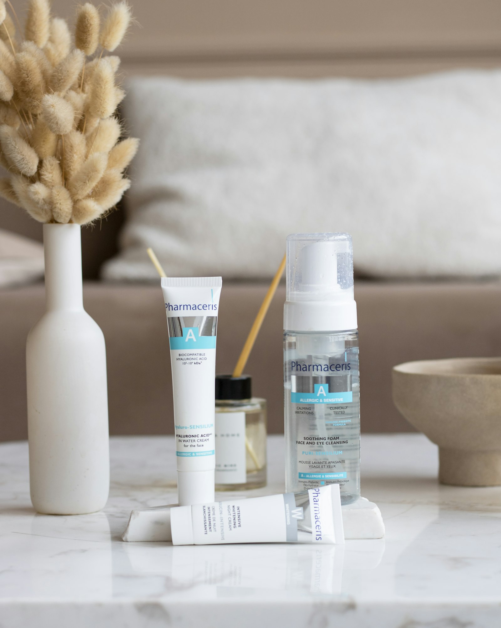 Beauty and personal-care skincare products styled on a marble surface