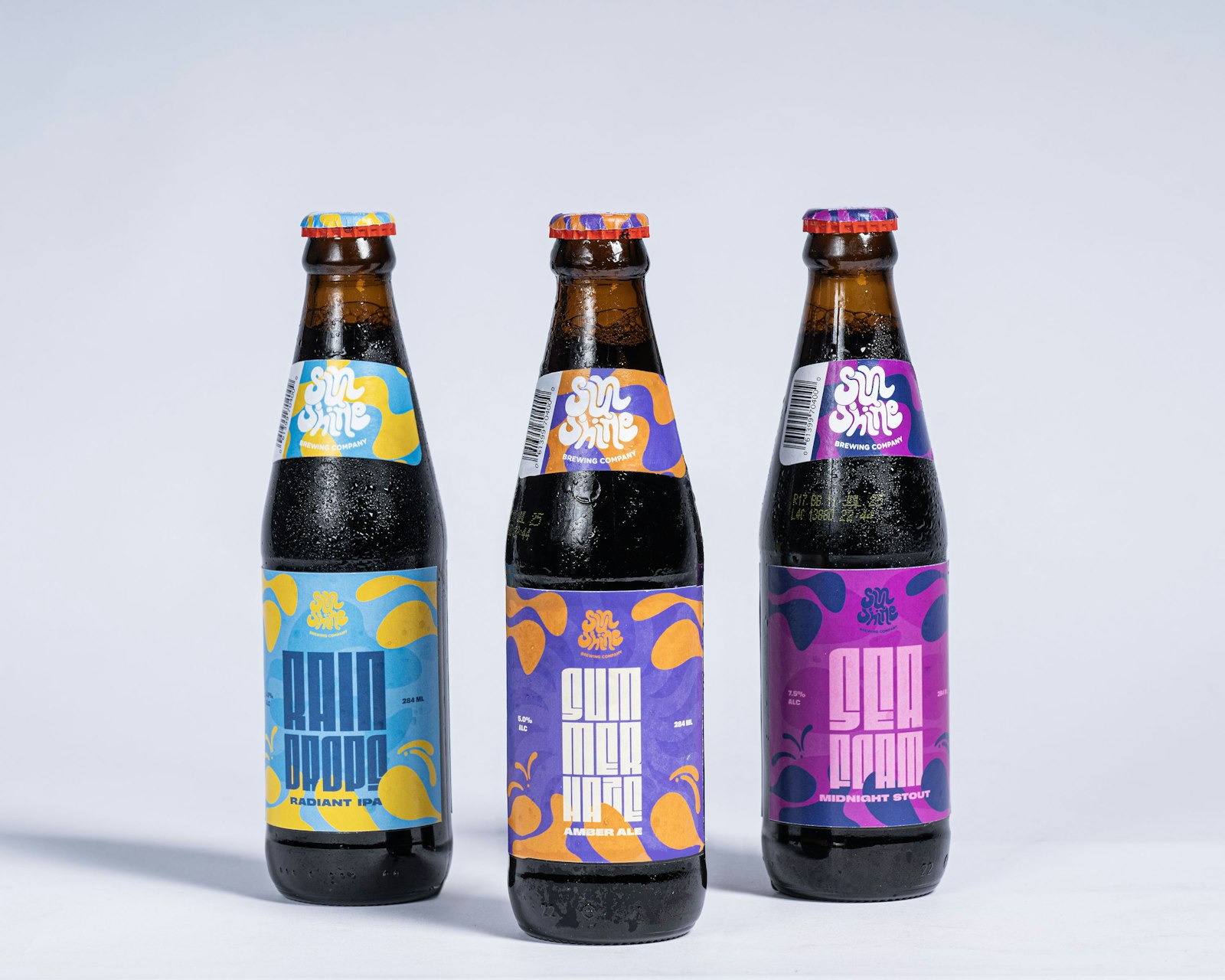 Specialty craft beverage bottles with colourful branded labels