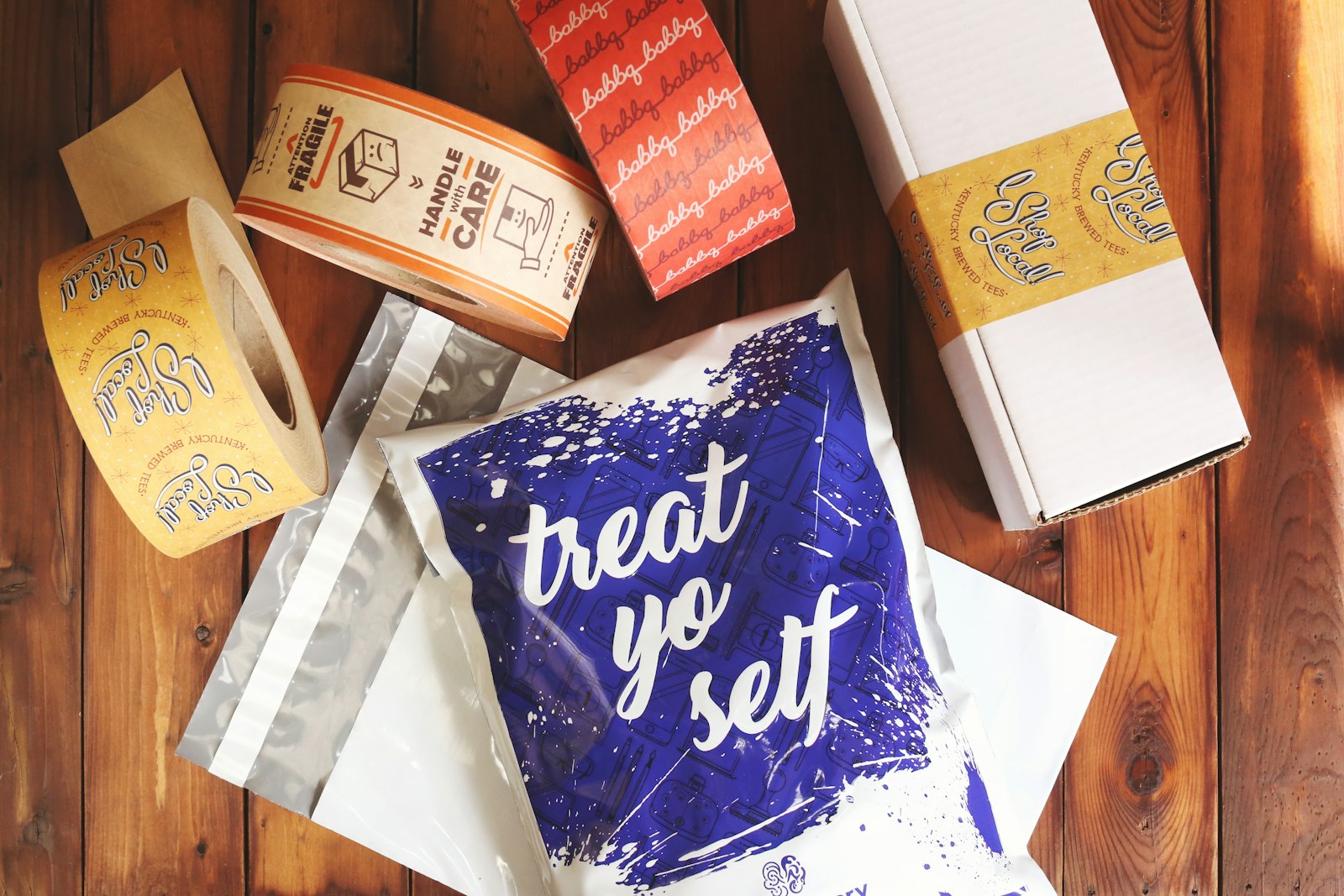 Branded direct-to-consumer packaging materials, custom mailers, and dispatch tape